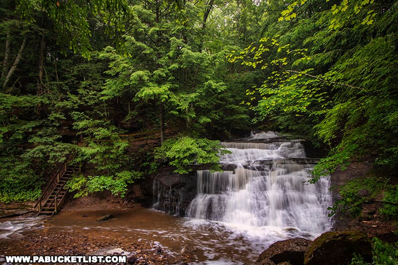 Wide-angle view of Hell's Hollow Falls and the stairs leading to the bottom of the falls.