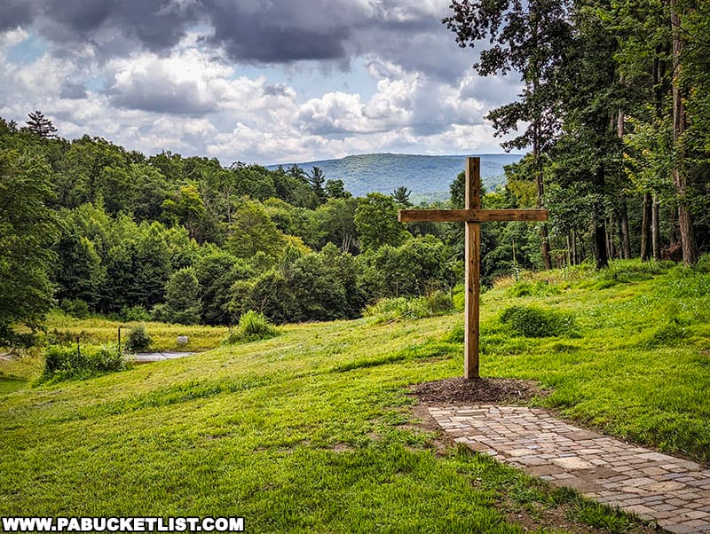 This 11 foot-tall wooden cross sits at the end of a pathway behind the Little Chapel in the Woods.