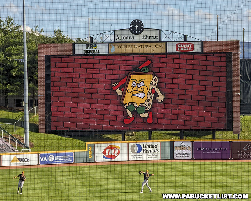 The Altoona Pizzas mascot resembling the square slice topped with yellow cheese customary of Altoona-style pizza.