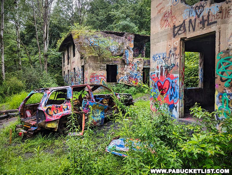 A burned-out car among the ruins of Concrete City.