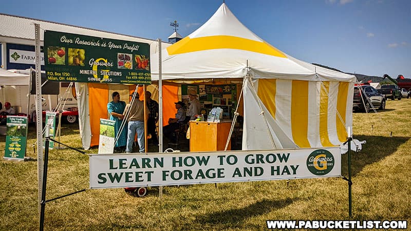A vendor selling minerals and offering advice on growing sweet forage and hay at Penn State's Ag Progress Days in Centre County Pennsylvania.
