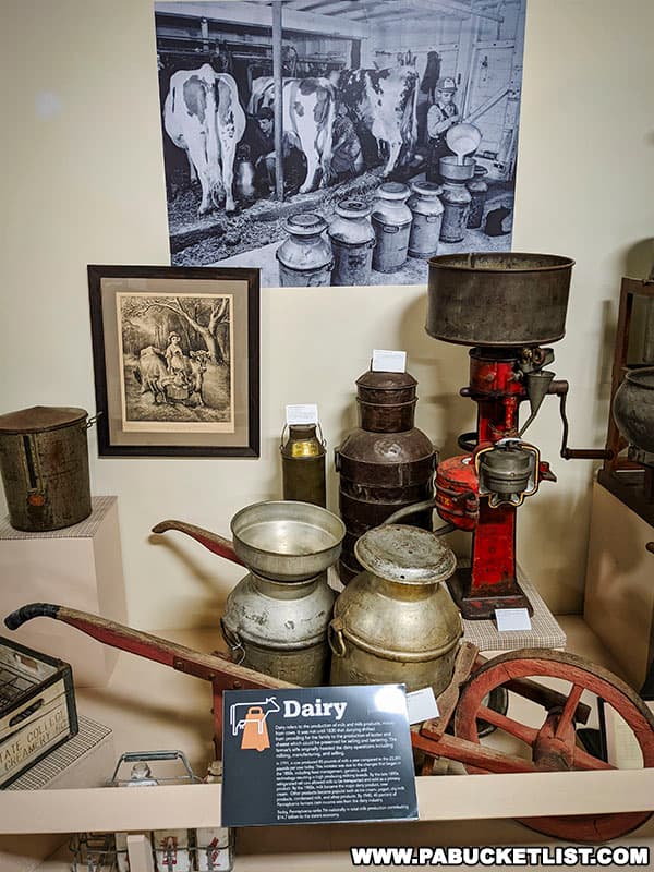 An exhibit featuring early dairy farming technology on display at the Pasto Agricultural Museum.