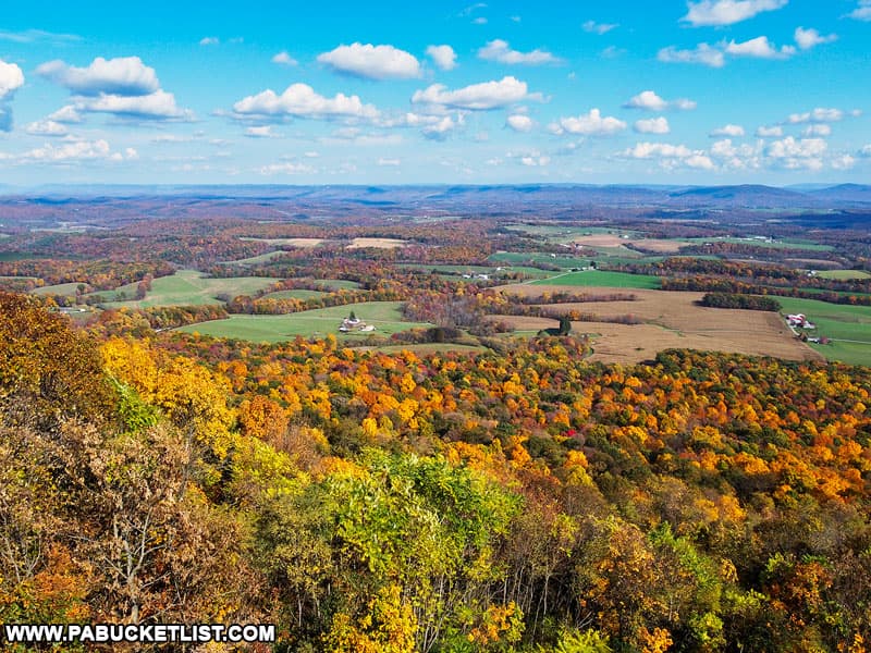 Looking out over farms and fields from Summit Road Vista at the height of fall foliage season in the Buchanan State Forest.