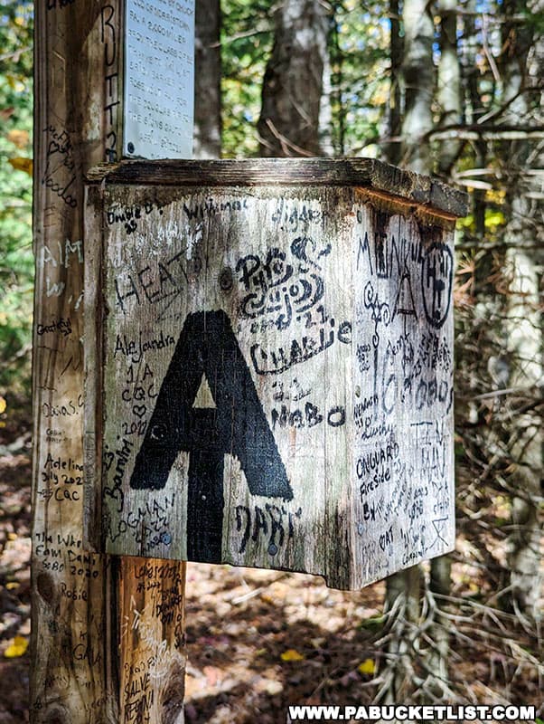 Many hikers celebrate reaching the symbolic halfway point of the Appalachian Trail by leaving their mark of the signpost or taking a commemorative photo.