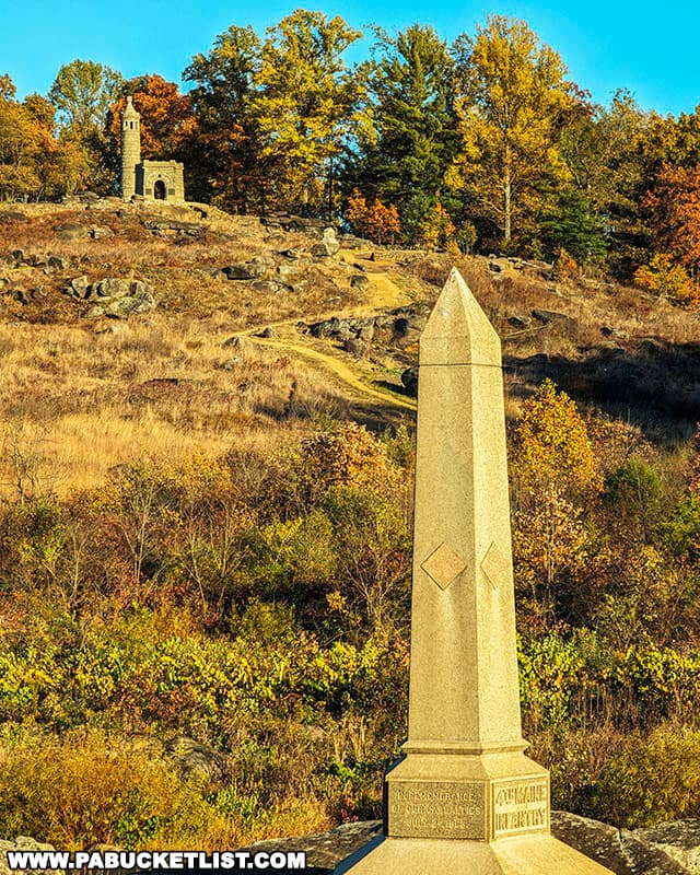 4th Maine Volunteer Infantry Regiment Monument in the foreground, fall foliage on Little Round Top in the background.
