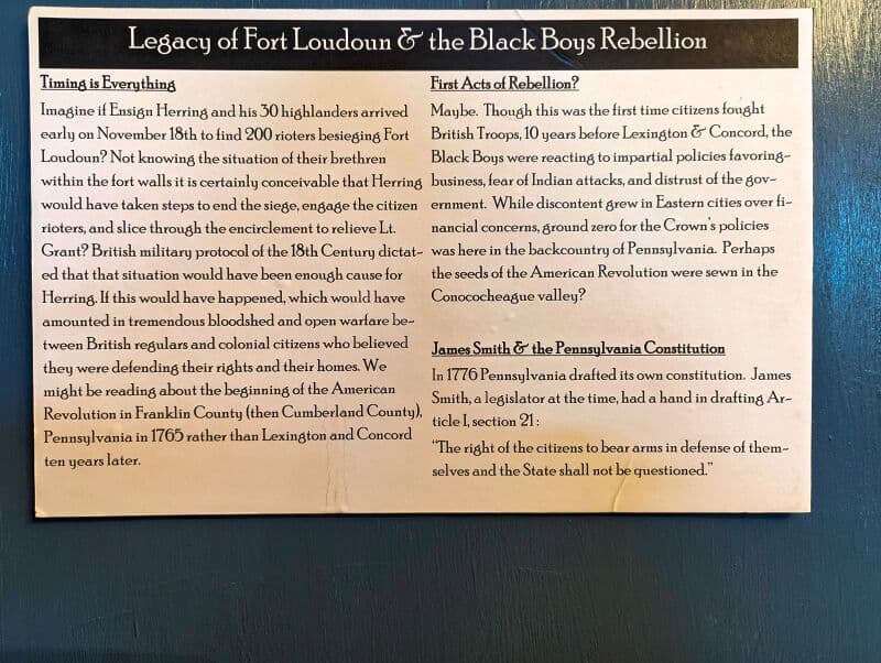 Informational display titled 'Legacy of Fort Loudoun & the Black Boys Rebellion'. The left side, under 'Timing is Everything', describes a hypothetical situation involving Ensign Herring and his highlanders arriving at Fort Loudoun and the possible consequences that could have unfolded. The right side touches on the first acts of rebellion against British Troops, emphasizing the significant role Pennsylvania played, and mentions James Smith's contribution to the Pennsylvania Constitution in 1776. The board provides historical context about the events leading up to the American Revolution. Displayed at Fort Loudoun in Franklin County, Pennsylvania.