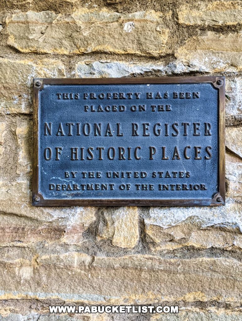 A close-up of a historic plaque on a stone wall reading "This property has been placed on the National Register of Historic Places by the United States Department of the Interior."