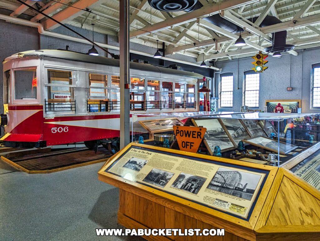 Inside the Electric City Trolley Museum in Scranton, Pennsylvania, with a vintage trolley car, educational displays, and a 'POWER OFF' sign in a spacious exhibit hall with industrial lighting.