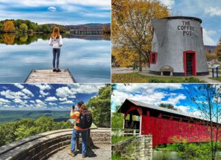 A collage of four photographs showcasing attractions in Bedford County, Pennsylvania. Top left: A woman stands on a wooden dock, gazing out over a calm lake reflecting autumnal trees and a bridge in the distance. Top right: The iconic Coffee Pot-shaped building with its gray walls, red accents, and a sign reading "THE COFFEE POT" against a backdrop of yellow fall foliage. Bottom left: A couple takes a selfie at a scenic overlook, with lush green hills stretching to the horizon under a blue sky with fluffy clouds. Bottom right: A historic red covered bridge over a serene creek, surrounded by verdant greenery and under a partly cloudy sky.