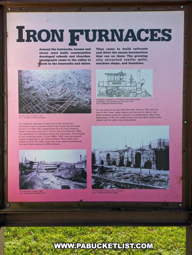 An informative display titled "IRON FURNACES" at the Scranton Iron Furnaces Historic Site in Scranton, PA, with a pink background. The board provides a historical context, stating that around the ironworks, communities developed with houses, stores, schools, churches, and that immigrants came to work in the ironworks and mines. It also discusses the building of railroads and the growth of the textile mills, machine shops, and foundries. The display includes three historical images: a bird's eye view of Scranton from 1873, a "Delaware, Lackawanna, and Western Railroad locomotive" from 1867, and two photos of the iron furnaces, one labeled "The Lackawanna Iron & Coal Company's Old Blast Furnace stack" and the other "The Last Blast Furnace, before restoration." These images are credited to the Lackawanna Historical Society.