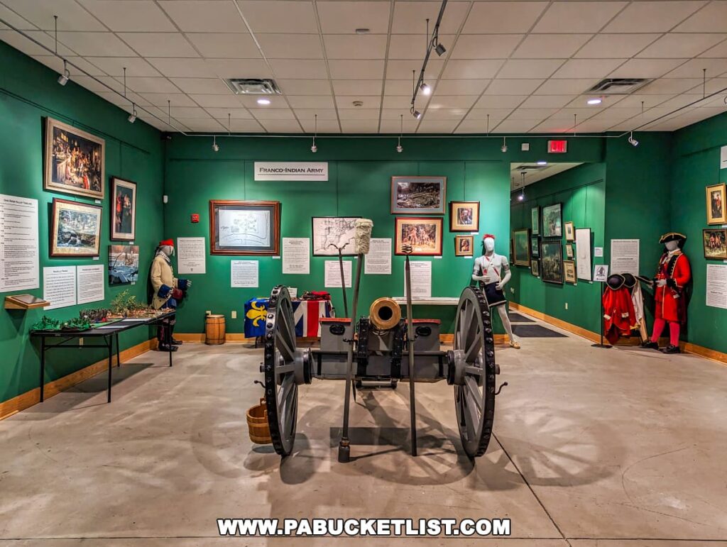 The main exhibit hall at Braddock's Battlefield History Center, showcasing a brass cannon in the foreground and mannequins dressed in period military uniforms. The walls are a rich green color, lined with framed historical paintings and informative displays, including one titled "Franco-Indian Army." The space is well-lit, creating an inviting atmosphere for learning about the historical events associated with the center.