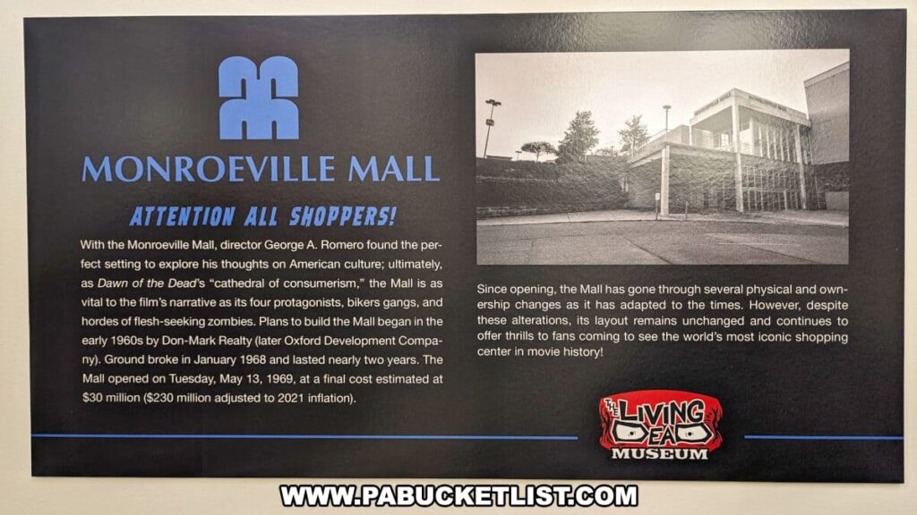 An informative display at the Living Dead Museum detailing the significance of Monroeville Mall as a filming location for George A. Romero's 'Dawn of the Dead'. The panel features bold blue text stating 'Monroeville Mall' and a callout 'Attention All Shoppers!', with a narrative about the mall's role as a 'cathedral of consumerism' in the film and its unchanged layout since its opening on May 13, 1969. A black and white photograph of the mall's exterior from the period complements the text. The Living Dead Museum's logo is prominently placed at the bottom right, connecting the historical context to the museum's theme.