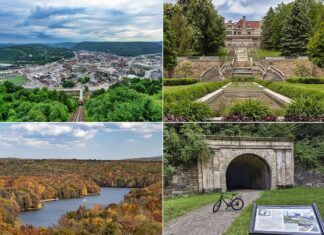 A collage of four photos highlighting points of interest in Cambria County, Pennsylvania. Top left: An expansive aerial view of a densely built town with multiple buildings, surrounded by green hills. Top right: A stately mansion with a cascading fountain in front, set against manicured lawns and a backdrop of trees. Bottom left: A sweeping landscape view of a river curving through a colorful, forested valley during fall. Bottom right: A historic stone railroad tunnel with a bicycle parked at its entrance and an interpretive sign in the foreground.