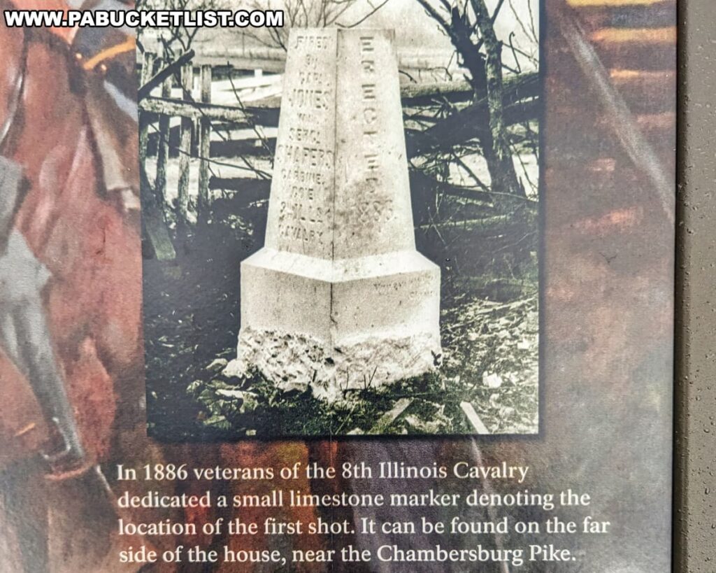 The photo shows a historic image of a small limestone marker with inscriptions, which was dedicated by veterans of the 8th Illinois Cavalry in 1886 to denote the location of the first shot at the Battle of Gettysburg. The marker is situated on the far side of the house, near the Chambersburg Pike. It appears to be an older photograph, evidenced by the monochrome color and aged look, depicting the marker standing alone in a field with bare trees in the background, signifying its historical significance and the reverence given by those who remembered the events that took place there.