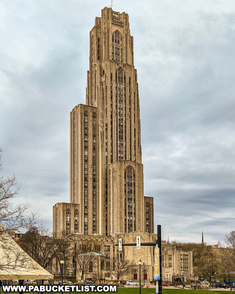 The Cathedral of Learning stands tall in the Oakland neighborhood of Pittsburgh, Pennsylvania, captured against an overcast sky. This iconic, Gothic Revival skyscraper, part of the University of Pittsburgh campus, towers over the surrounding landscape with its impressive height and intricate architectural details. Its presence dominates the scene, representing the academic heritage of the area. This historic landmark serves as a visual marker of the intellectual legacy and the cultural environment that once neighbored Forbes Field, the original home of the Pittsburgh Pirates baseball team.