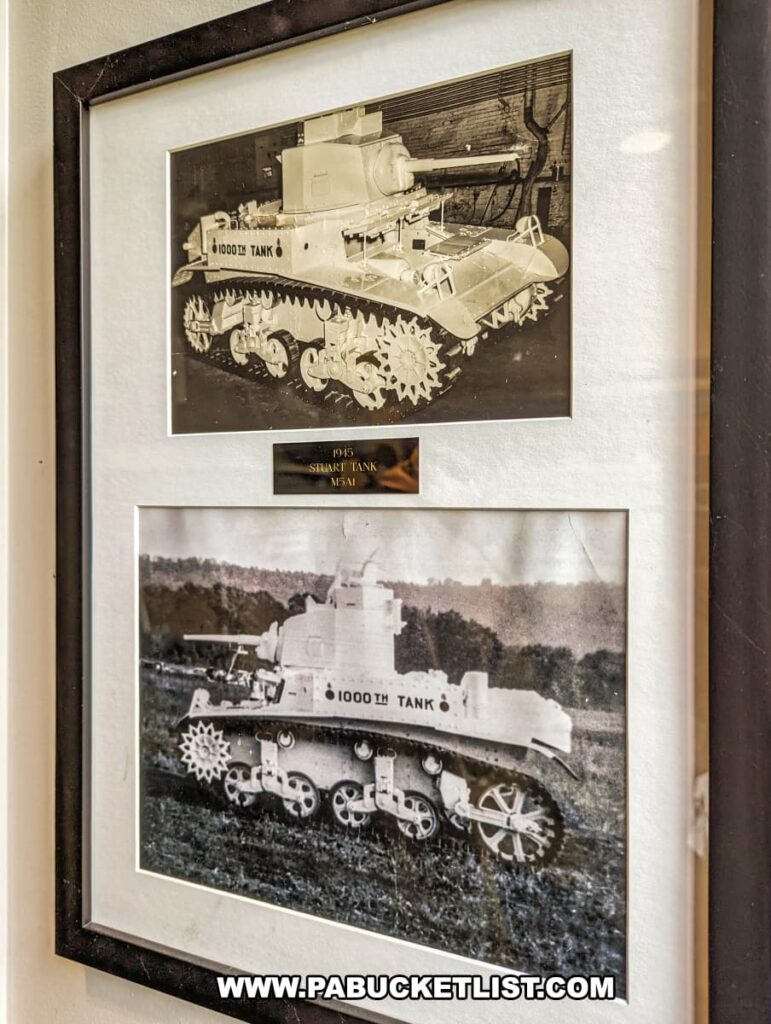 Framed photographs displayed at the Stuart Tank Museum in Berwick, Pennsylvania, celebrate the manufacturing milestones of the M3A1 Stuart tank, including the 1000th tank produced, marked by signage on the tanks in the images.