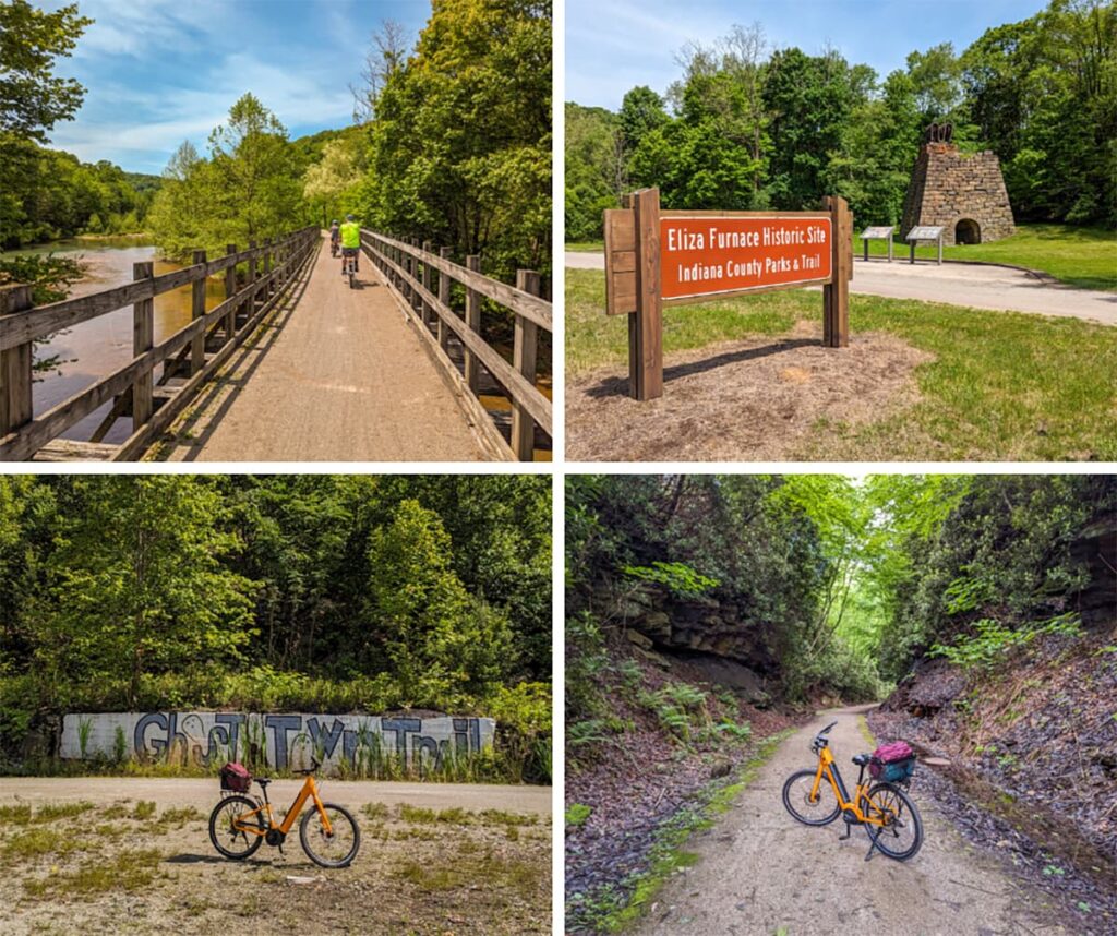 Four images from a bike ride along the Ghost Town Trail in western Pennsylvania. The first image shows a cyclist riding over a wooden bridge surrounded by lush green trees. The second image features a sign for the Eliza Furnace Historic Site, with a stone furnace and informational displays in the background. The third image captures an orange bicycle parked in front of a graffiti-covered wall that reads "Ghost Town Trail" amidst dense forest. The fourth image depicts a narrow, tree-lined trail with steep rock walls, where the same orange bicycle is parked on the path.
