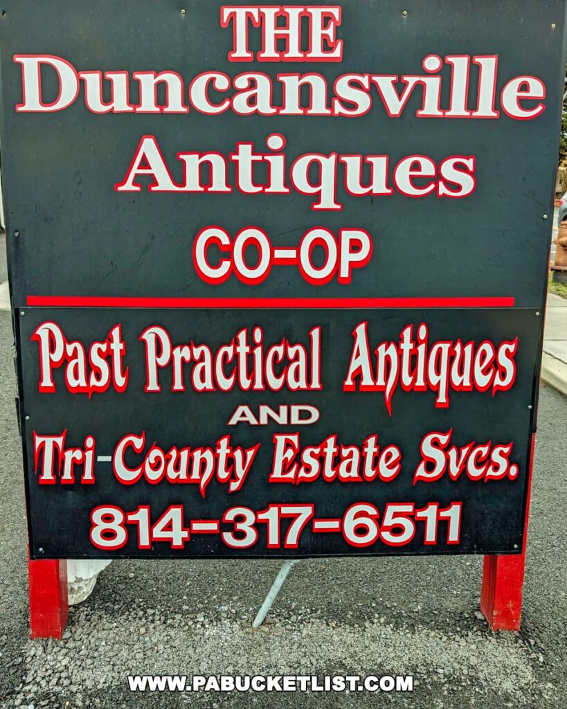 Close-up view of a sign for the Duncansville Antiques Co-Op in Blair County, Pennsylvania, highlighting the store's partnership with Past Practical Antiques and Tri-County Estate Services.