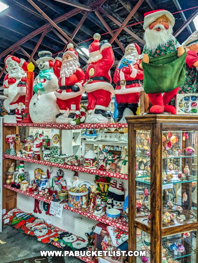 Festive display of vintage Christmas decorations at the Duncansville Antiques Co-Op in Blair County, Pennsylvania, featuring an assortment of Santa Claus and snowman blow molds arranged on top of shelves filled with holiday-themed collectibles, ornaments, and seasonal décor.