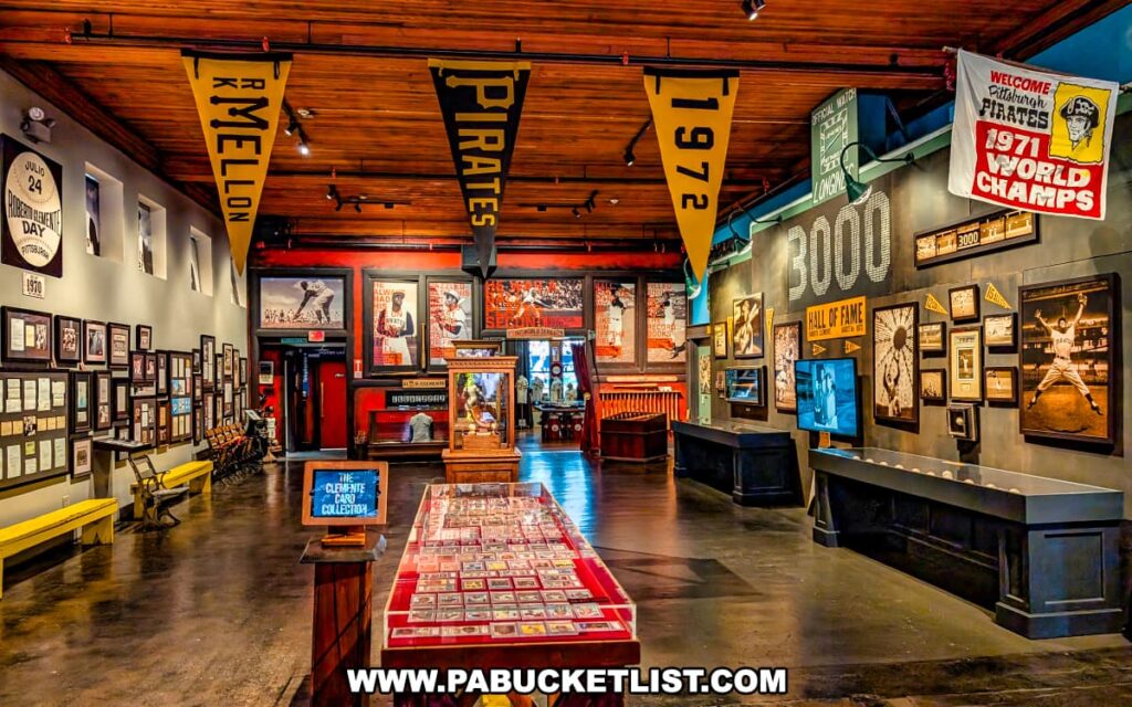 Interior exhibit at the Roberto Clemente Museum in Pittsburgh, PA, showcasing an extensive collection of Clemente memorabilia including framed photographs, baseball cards, historic pennants, and Pittsburgh Pirates championship banners, with warm wood ceilings and dramatic lighting enhancing the tribute to his career milestones and Hall of Fame legacy.