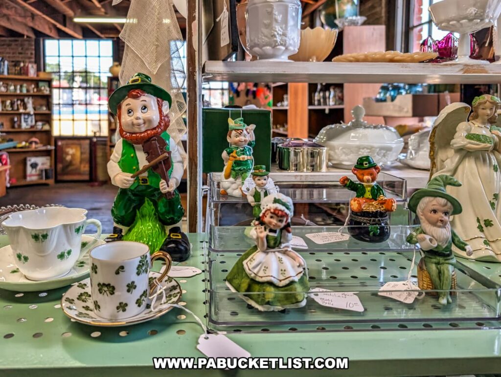 Festive display at Central Station Antiques in Scranton, PA featuring St. Patrick’s Day-themed figurines, shamrock-patterned teacups, vintage glassware, and decorative collectibles arranged on shelves.