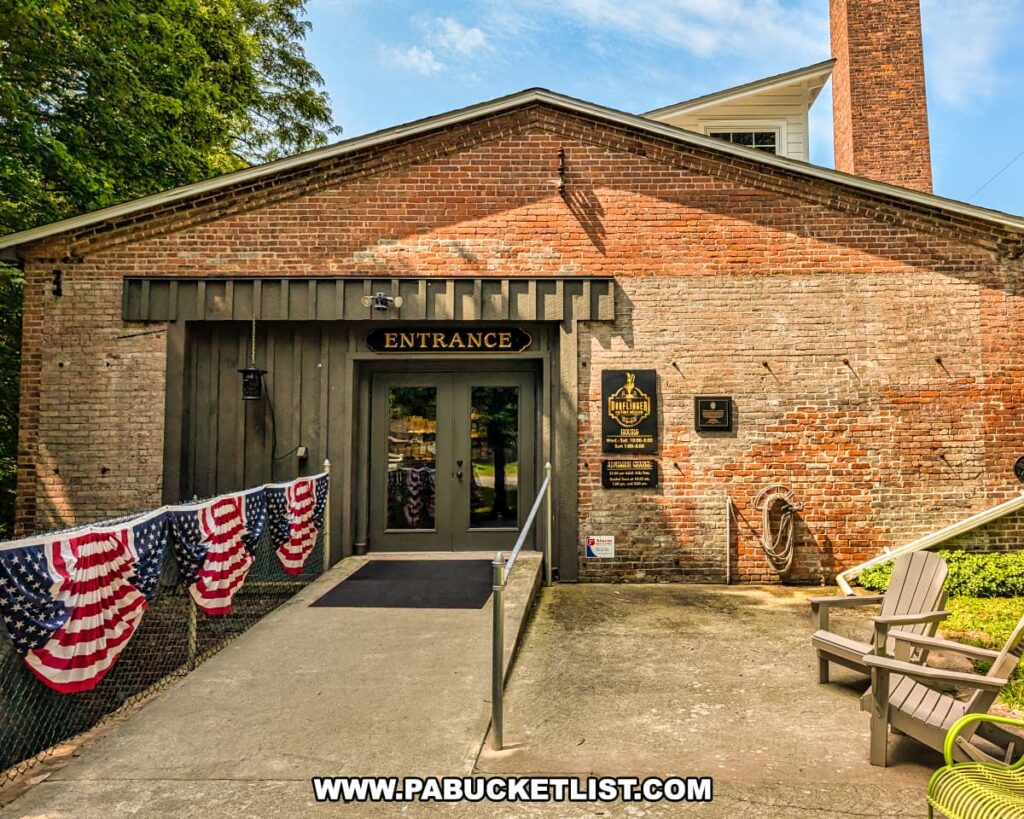 Entrance to the Dorflinger Factory Museum in Wayne County, PA, housed in a historic brick building adorned with patriotic bunting and museum signage.