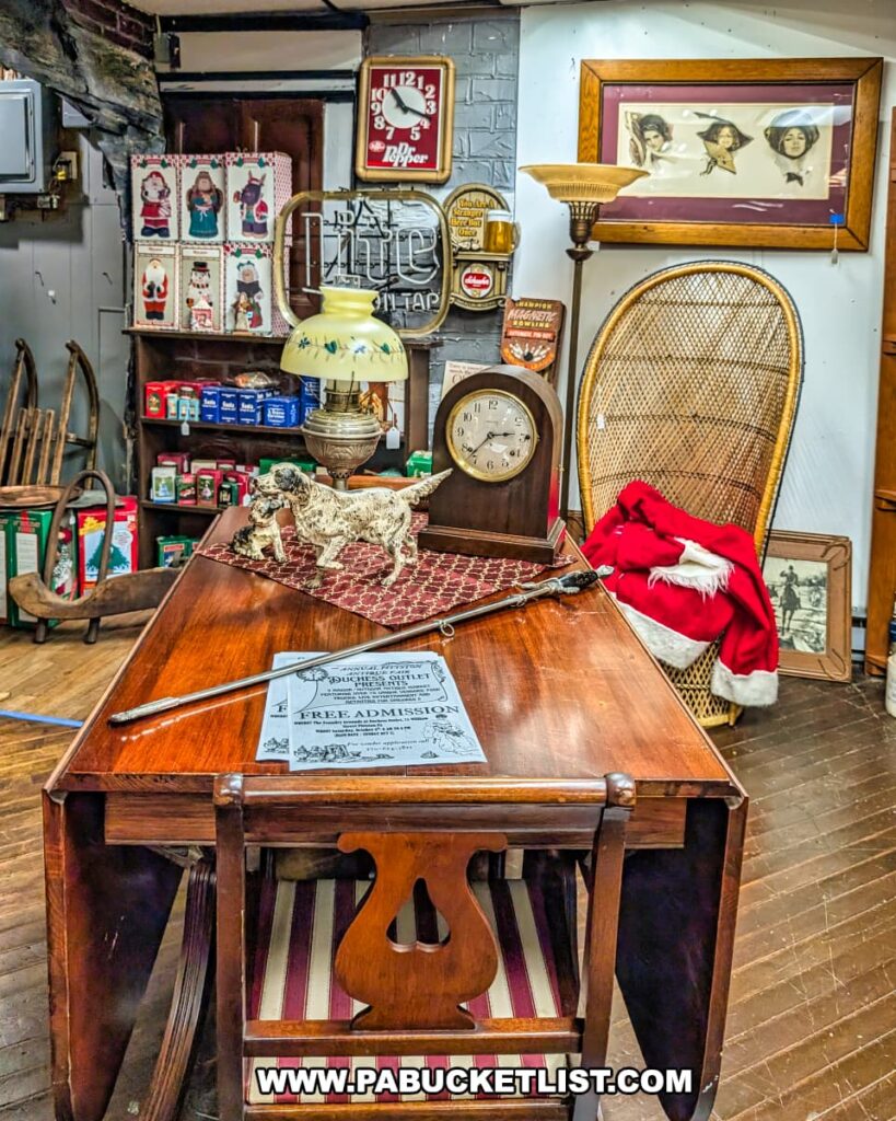 A warm and inviting scene inside an antique store, featuring a polished wooden drop-leaf table laden with vintage items like a ceramic dog statue, an antique lamp with a fringed shade, and an old clock. In the background, shelves display various collectibles and wall decor, including retro signs and framed art, creating a rich atmosphere of historical charm. A wicker chair with a red Santa hat adds a touch of whimsy to the right side of the image.