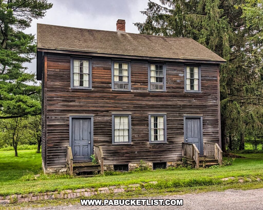 Two-story wooden miner’s double home at Eckley Miners’ Village in Luzerne County, Pennsylvania, with weathered siding, simple entrances, and small porches, representing the shared housing typical of 19th-century coal mining families in the patch town.