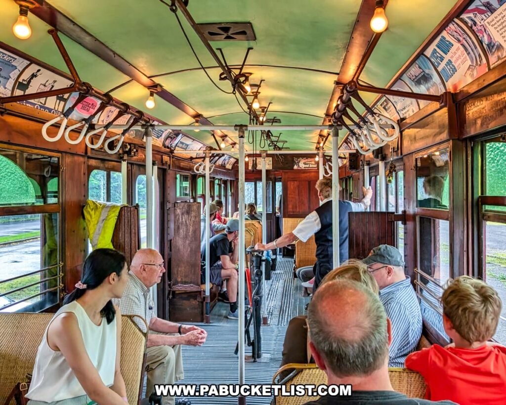 Passengers seated inside a vintage trolley car during the Electric City Trolley Museum’s 5.5 mile round-trip excursion in Lackawanna County, with wooden paneling, overhead advertisements, and warm lighting creating a nostalgic atmosphere.