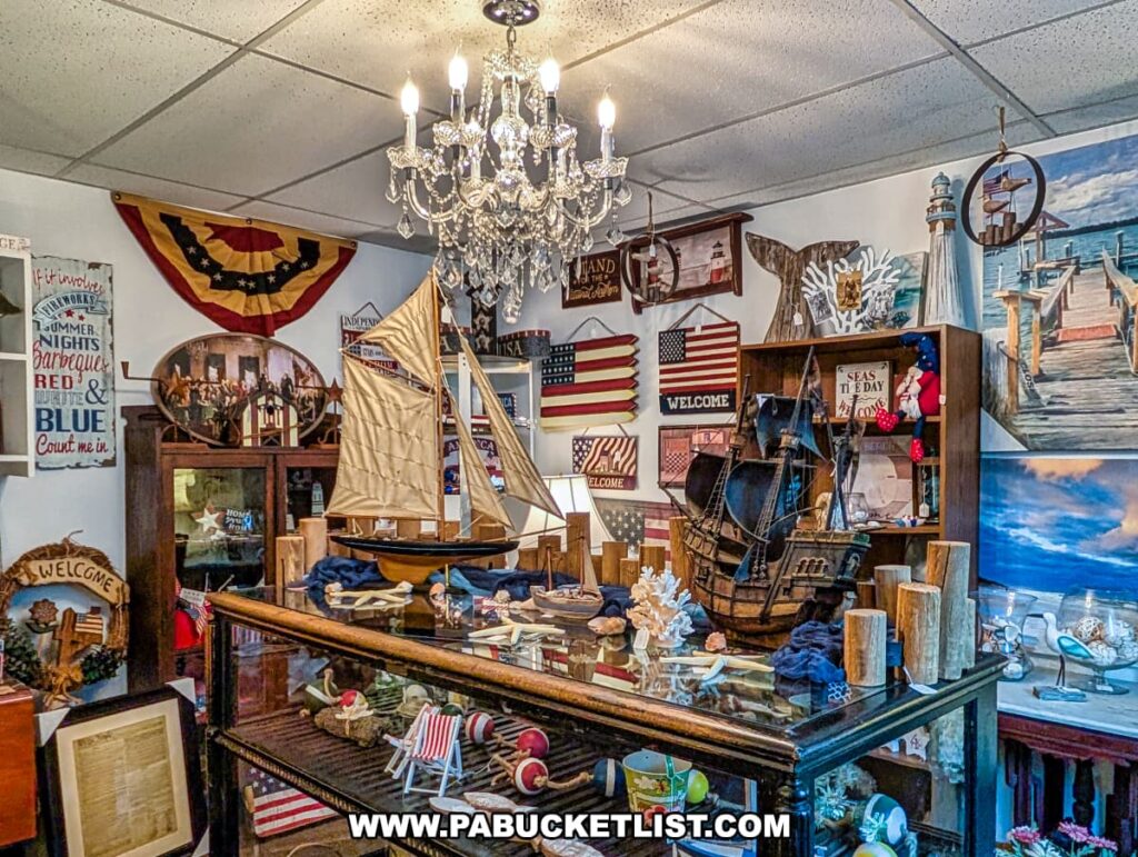 Nautical-themed merchandise inside the Jackson Mansion gift shop, featuring model ships, patriotic decor, seashells, and vintage-style signs beneath a crystal chandelier.