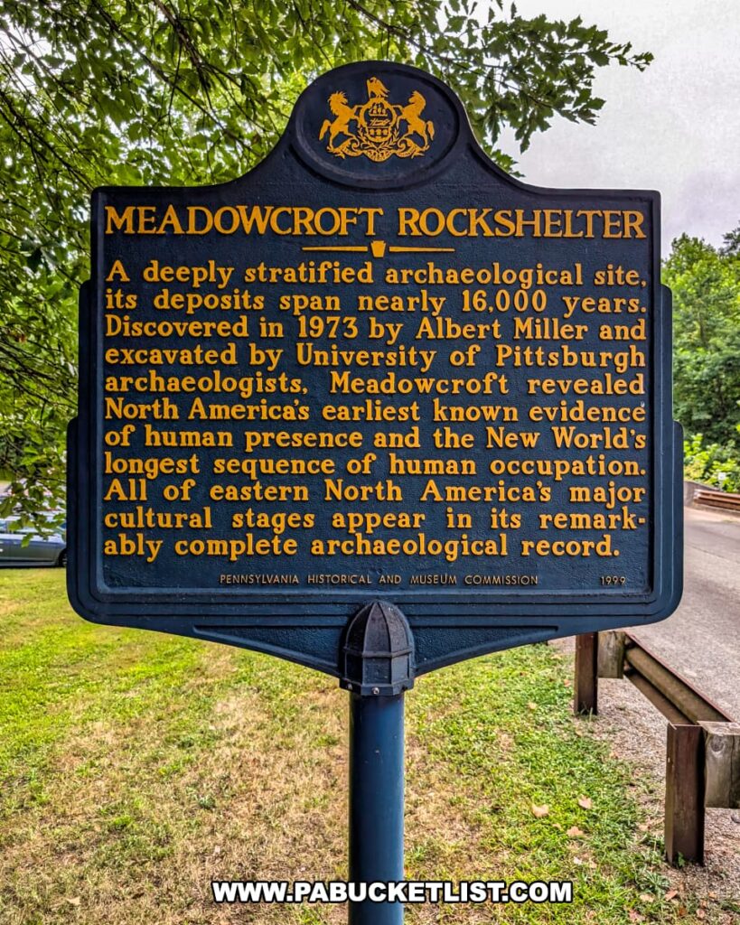 State historical marker at Meadowcroft Rockshelter in Washington County, PA, describing the site’s discovery in 1973, its nearly 16,000 years of deposits, and its significance as North America’s earliest known evidence of human presence and continuous occupation.