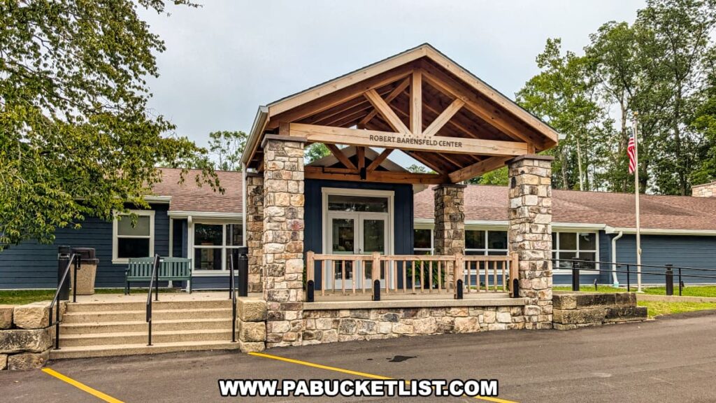 The Robert Baresnfeld Center at Meadowcroft Rockshelter and Historic Village in Washington County, PA, featuring a stone and timber entrance with a covered porch leading into the visitor center.