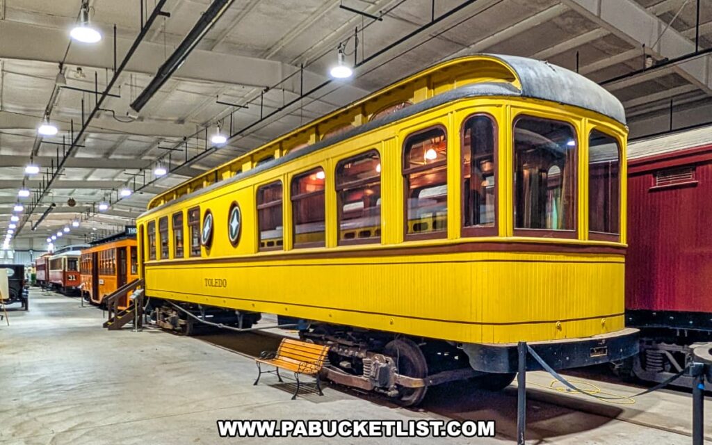 Bright yellow vintage Toledo streetcar on display inside the Trolley Display Building at the Pennsylvania Trolley Museum in Washington County, Pennsylvania.