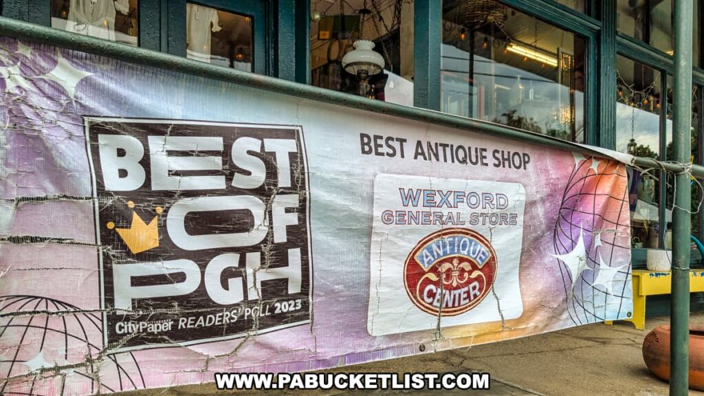 Banner outside Wexford General Store Antiques in Allegheny County, PA displaying a “Best of Pittsburgh 2023” award for Best Antique Shop, with the store’s logo and storefront windows visible behind it.