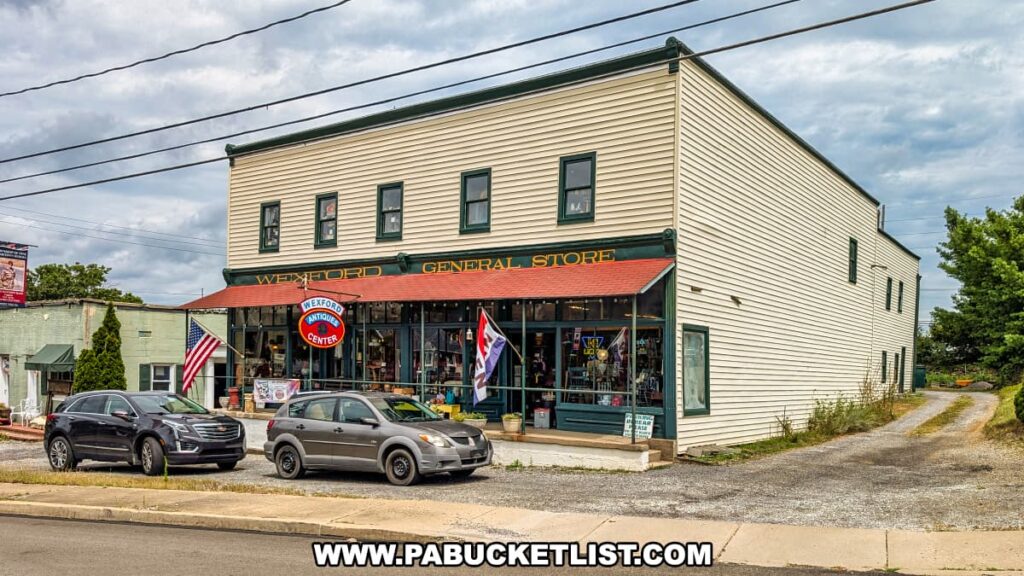 Exterior view of Wexford General Store Antiques in Allegheny County, PA, a large two-story building with a red roof overhang, storefront windows filled with antiques, and American flags displayed out front.