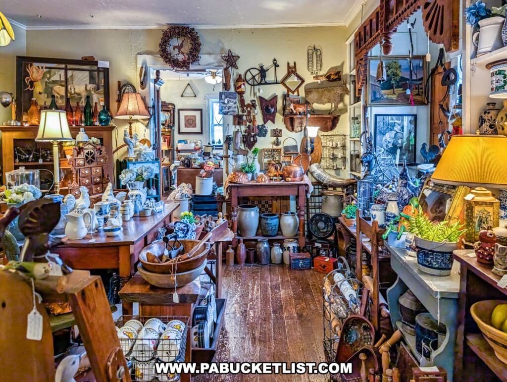Room inside Wexford General Store Antiques in Allegheny County, PA filled with vintage kitchenware, blue-and-white china, wooden bowls, crocks, and decorative farmhouse-style antiques displayed on rustic wooden tables and shelves.