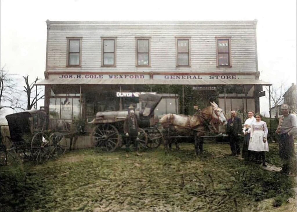 Historic photograph of the Wexford General Store in Allegheny County, PA showing the Jos. H. Cole storefront with horse-drawn carriages, wagons, and several people posed in front of the building in the early 20th century.