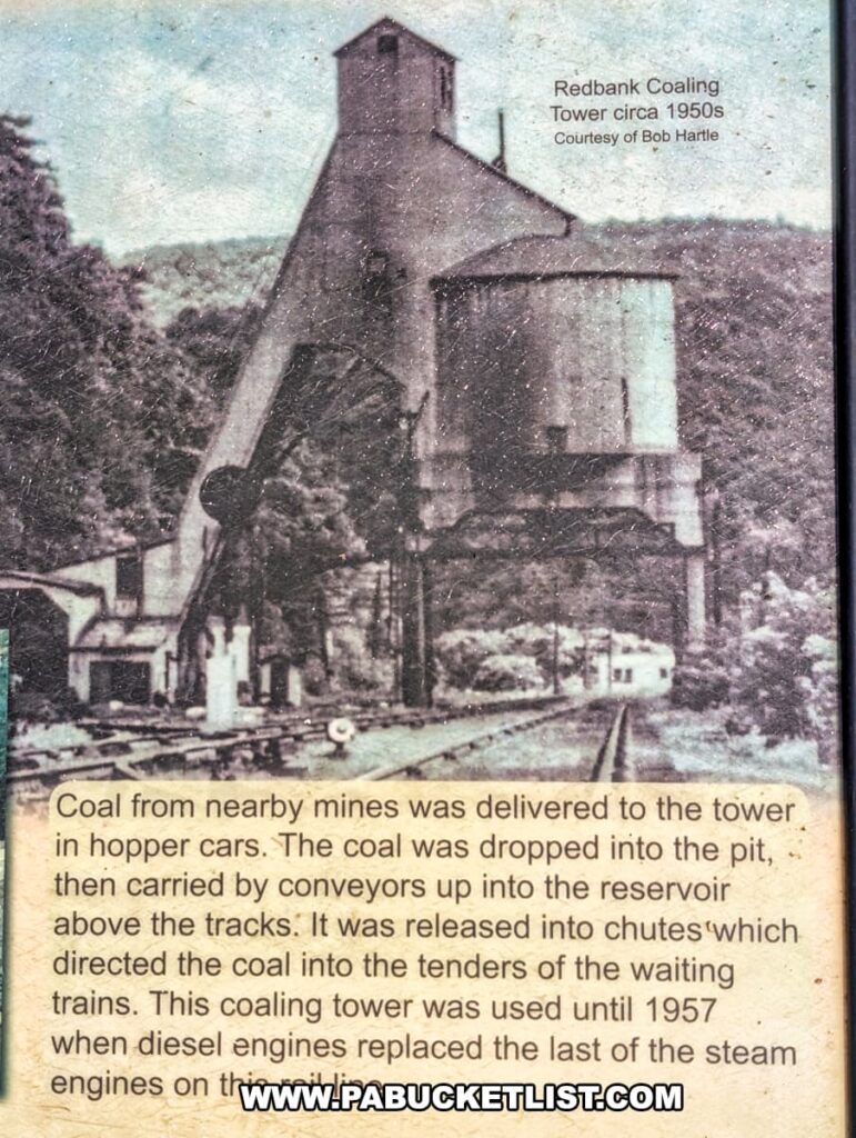 Historic sign along the Armstrong Trail in western Pennsylvania featuring a 1950s photo of the Redbank Coaling Tower, with text explaining how coal from nearby mines was loaded into trains and noting that the tower was used until 1957 when diesel engines replaced steam locomotives.