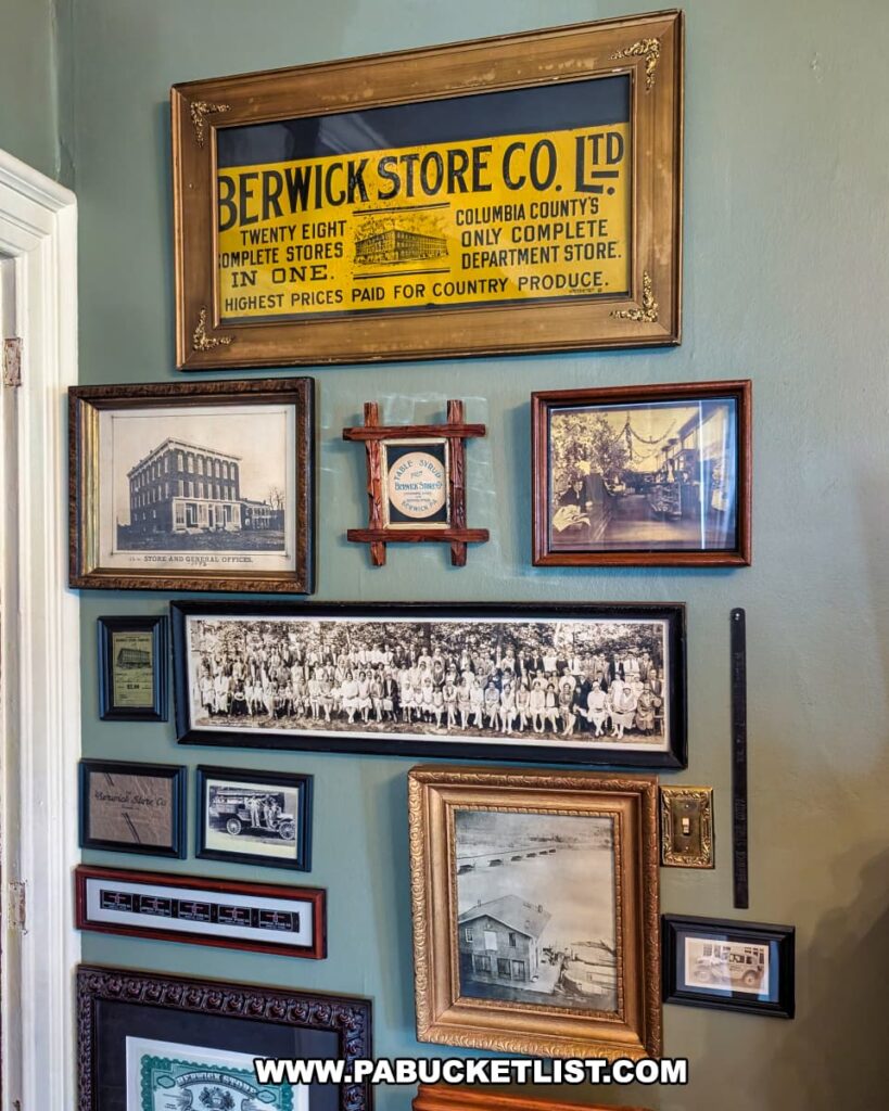 Framed historic photographs, documents, and memorabilia from the Berwick Store Co. displayed on a wall at the Berwick Historical Society Museum in Columbia County, PA, highlighting the history of this once-prominent department store and its role in the local community.