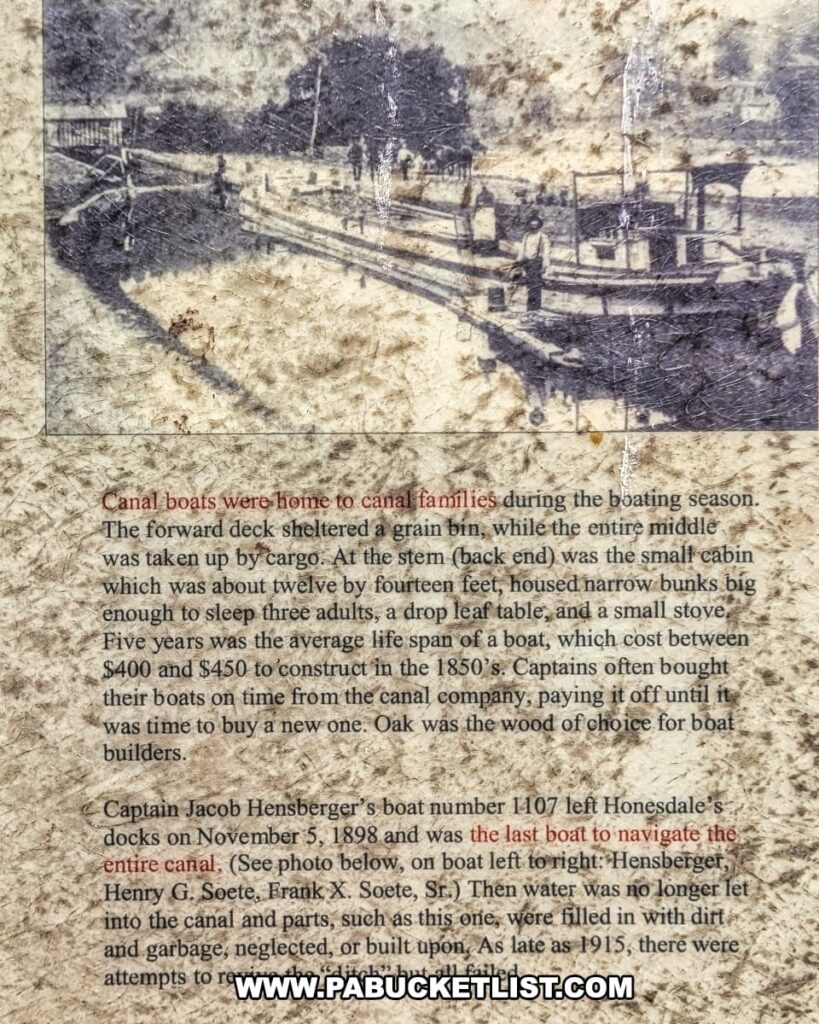 Interpretive sign at the D\&H Canal Park in Wayne County, Pennsylvania, featuring a historic photo of canal boats and text explaining how canal families lived aboard, the cost and lifespan of boats in the 1850s, and noting that Captain Jacob Hensberger’s boat was the last to navigate the canal in 1898.