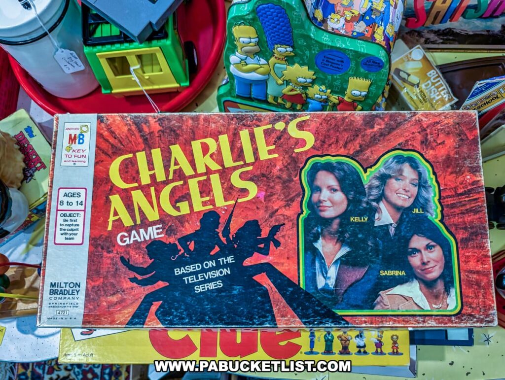 Vintage Milton Bradley Charlie’s Angels board game on display at Plains Antiques in Luzerne County, PA, surrounded by other retro toys, collectibles, and board games in this two-level multi-vendor antique shop near Wilkes-Barre.