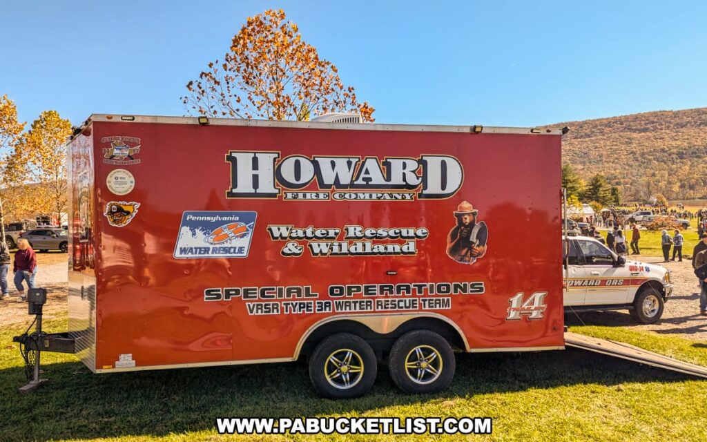 A Howard Fire Company trailer labeled “Water Rescue & Wildland Special Operations” is parked on display at the Punkin Chunkin Fall Festival at Bald Eagle State Park in Centre County, PA, with visitors and autumn foliage in the background.