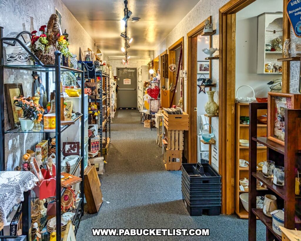 Interior hallway at Vintage Secrets Antiques in Canonsburg, Washington County, PA, lined with vendor booths and shelves displaying a variety of antiques, collectibles, glassware, records, and vintage décor items in the multi-level antique mall.