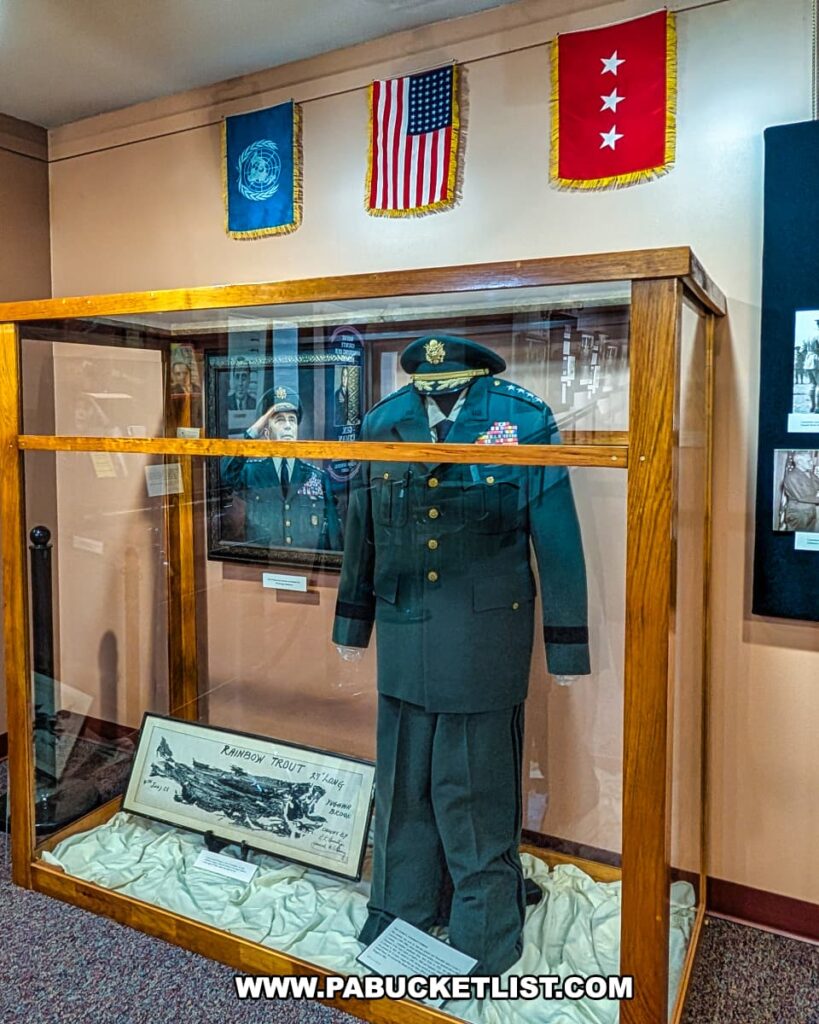 Exhibit at the Wayne County Historical Society Museum in Honesdale, Pennsylvania showcasing the military uniform of General Lyman Lemnitzer, a four-star U.S. Army general and Wayne County native, displayed in a glass case alongside photos, flags, and memorabilia honoring his service.