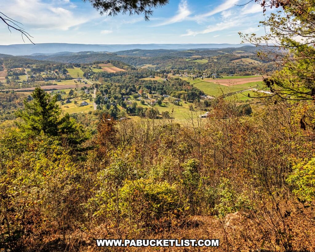 Expansive view from Katy Jane West Vista at Rider Park in Lycoming County, Pennsylvania, overlooking rolling farmland, scattered homes, and distant ridges under a bright blue autumn sky.