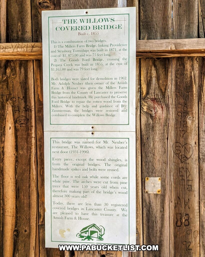 Historical sign inside the Willows Covered Bridge in Lancaster County, Pennsylvania, describing how the 1962 bridge was created by combining the 1871 Millers Farm Bridge and the 1855 Goods Ford Bridge, preserved using original materials and named after the nearby Willows Restaurant.