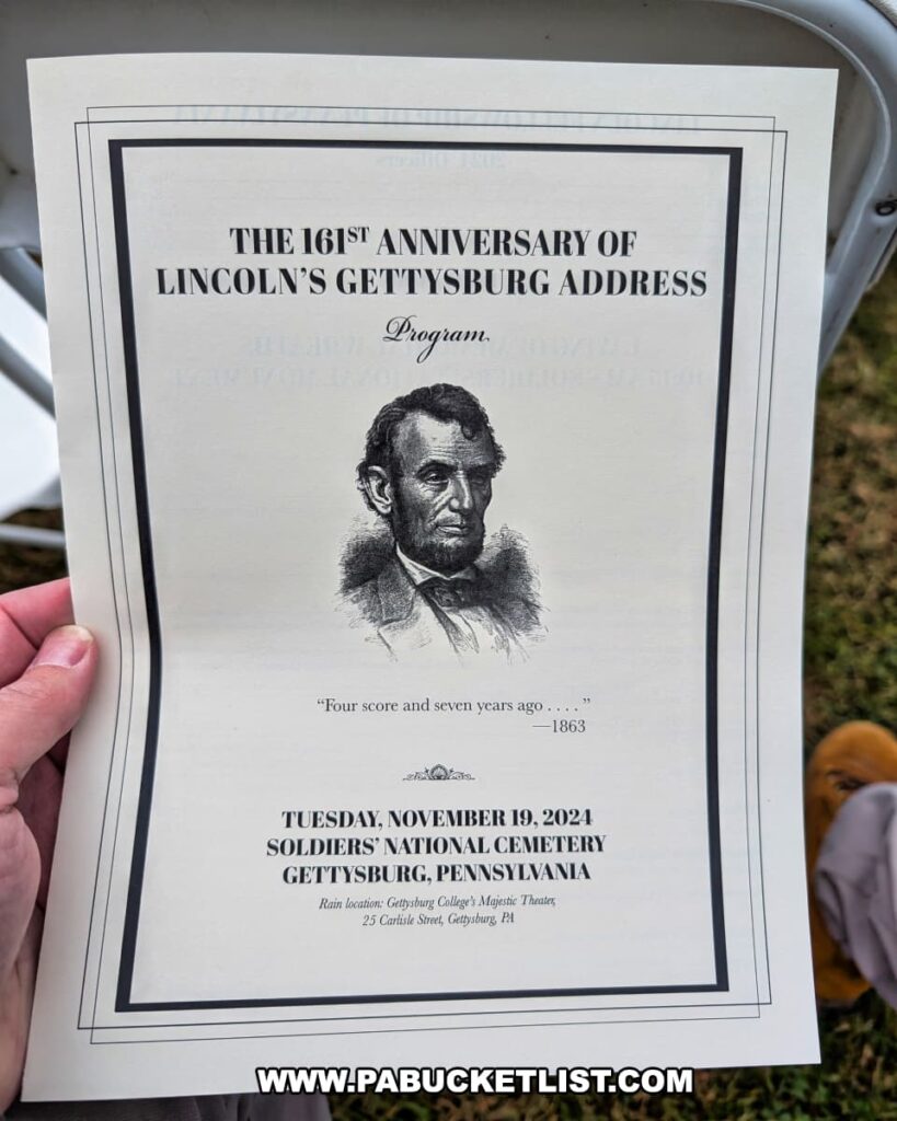 Close-up of the printed program for the 161st anniversary of Lincoln’s Gettysburg Address, featuring an illustration of Abraham Lincoln and event details for the 2024 Dedication Day ceremony at Soldiers’ National Cemetery in Gettysburg, Pennsylvania.