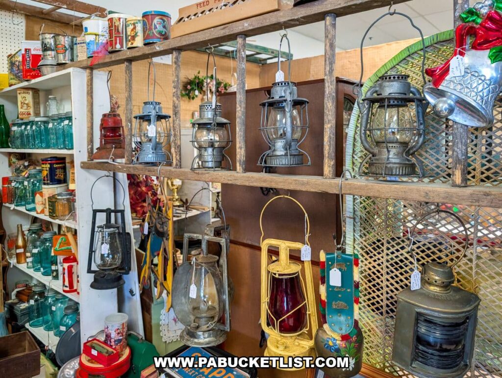 Display of vintage lanterns hanging from a rustic wooden rack at Black Rose Antiques in Hanover, Pennsylvania, with shelves of old-fashioned tins, glass bottles, and collectibles visible in the background.