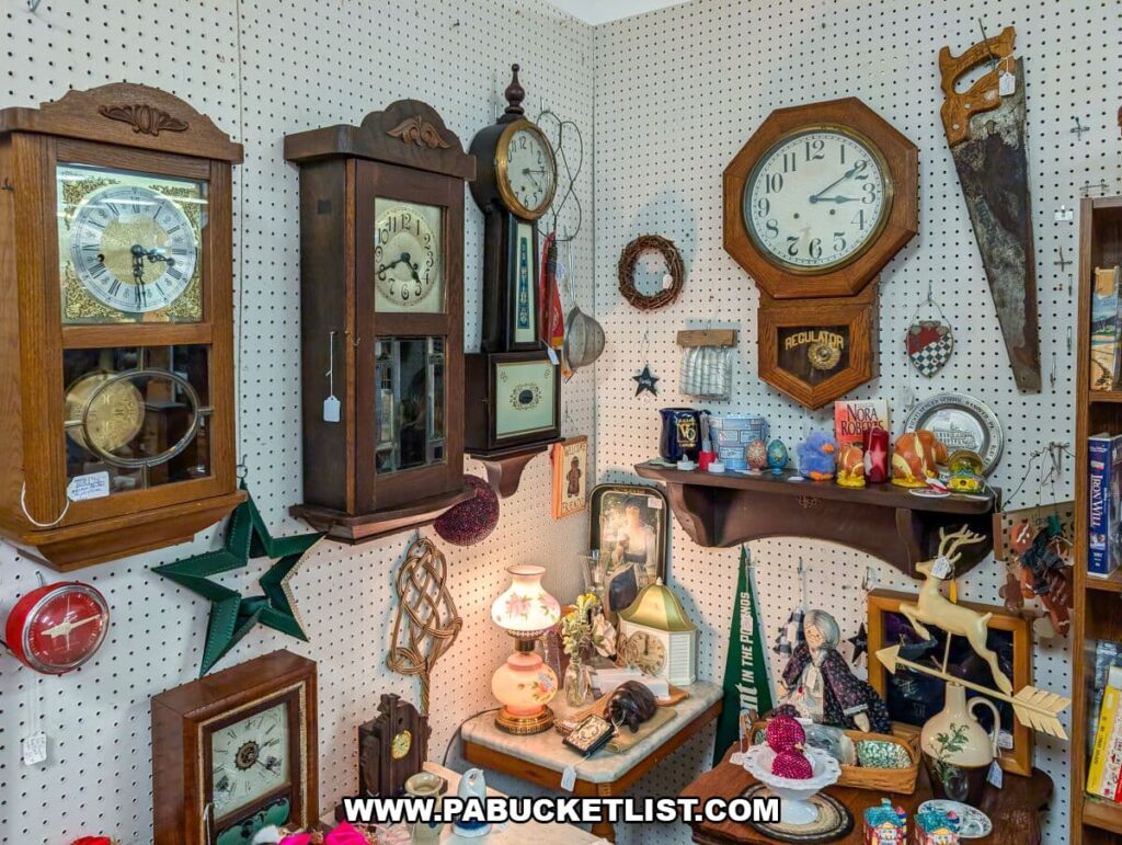 Vintage clocks and home décor booth at Black Rose Antiques in Hanover, Pennsylvania, featuring antique wall clocks, a rustic saw, decorative shelves, figurines, framed art, ceramics, and small collectibles arranged on pegboard and tables.
