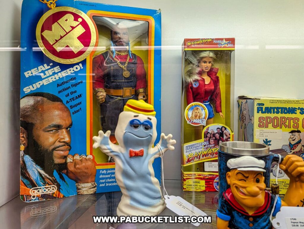Vintage toy display at Morning Sun Marketplace in York County, PA, featuring a boxed Mr. T action figure, a Baywatch lifeguard doll, a Ghostbusters-style Stay Puft figure, and Popeye memorabilia.